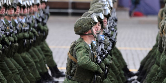 Russian service members march during a military parade on Victory Day, which marks the 77th anniversary of the victory over Nazi Germany in World War Two