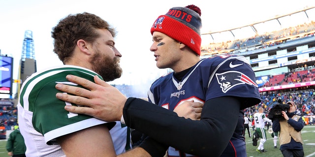 Tom Brady of the New England Patriots, right, talks with Ryan Fitzpatrick of the New York Jets at Gillette Stadium in Foxborough, Massachusetts, on Dec. 24, 2016.