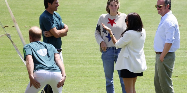 Prince Harry gets a serious glutes stretch while playing polo with longtime pal Nacho Figueras 2 Prince Harry got his stretch on as his wife Meghan Markle chats with friends in the field.