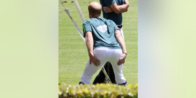Prince Harry put emphasis on his glutes while stretching before the match.