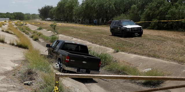 A police vehicle is seen parked near of a truck believed to belong to the suspect of a shooting at Robb Elementary School in Uvalde, Texas, on Tuesday, May 24.