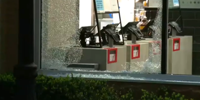 Windows shattered ar a McDonald's following a mass shooting in downtown Chicago on May 19, 2022.