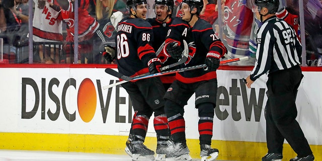 Carolina Hurricanes' Sebastian Aho (20) celebrates his tying goal with Teuvo Teravainen (86) and Seth Jarvis, center, during the third period of Game 1 of an NHL hockey Stanley Cup second-round playoff series in Raleigh, N.C., Wednesday, May 18, 2022.