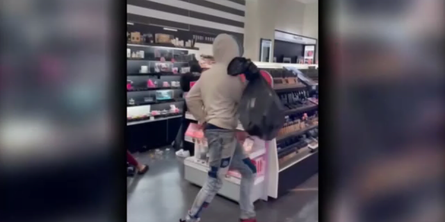 Shoplifters steal from a Sephora store in Los Angeles.