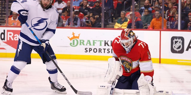 Florida Panthers goaltender Sergei Bobrovsky (72) makes a save as Tampa Bay Lightning left wing Pat Maroon (14) looms overhead during the first period of Game 1 of an NHL hockey second-round playoff series Tuesday, May 17, 2022, in Sunrise, Fla.