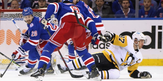 Jacob Trouba of the New York Rangers checks Sidney Crosby of the Pittsburgh Penguins at Madison Square Garden on May 11, 2022.