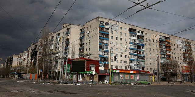 Destroyed Ukrainian apartment house after military attack, cloudy skies