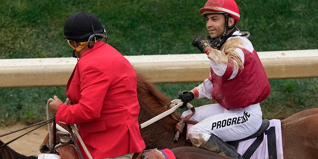 Rich Strike (21), with Sonny Leon aboard, is led to the winner's circle after winning the 148th running of the Kentucky Derby horse race at Churchill Downs Saturday, May 7, 2022, in Louisville, Ky.