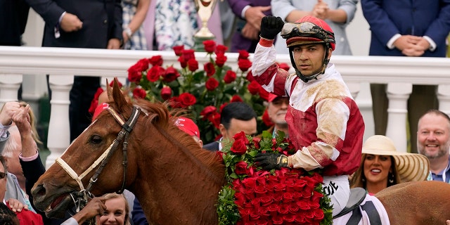 Jockey Sonny Leon rides Rich Strike in the winner's circle after winning the 148th running of the Kentucky Derby horse race at Churchill Downs Saturday, May 7, 2022, in Louisville, Ky.