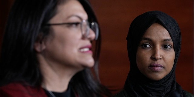 Rep. Ilhan Omar, D-Minn., listens to Rep. Rashida Tlaib, D-Minn., speak during a press conference on Islamophobia on Capitol Hill November 30, 2021 in Washington.
