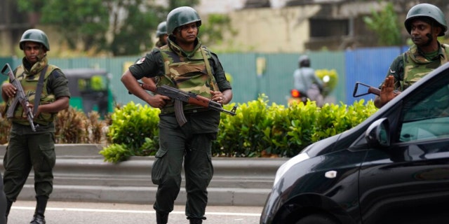 Soldiers from the Sri Lankan army stand guard outside the prime minister's residence a day after clashes between government supporters and anti-government protesters in Colombo, Sri Lanka on Tuesday 10 May 2022.