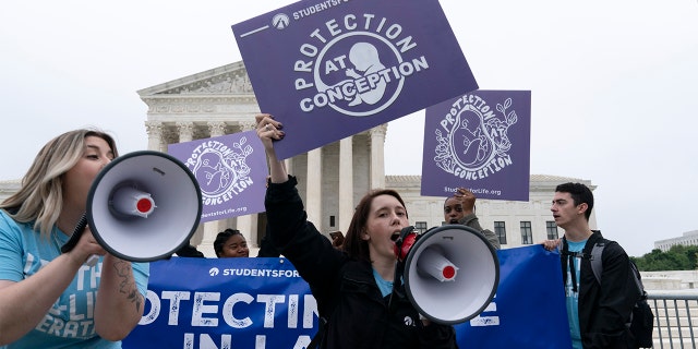 Demonstrators protest outside of the U.S. Supreme Court Tuesday, May 3, 2022 in Washington.