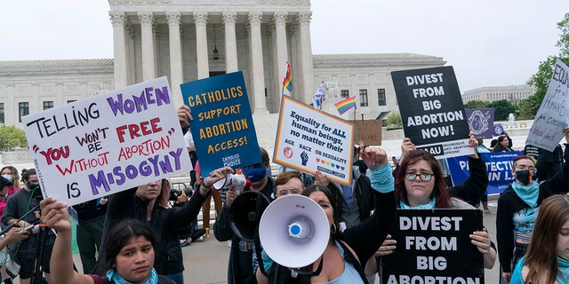 Demonstrators protest outside of the U.S. Supreme Court Tuesday, May 3, 2022, in Washington. (AP Photo/Jose Luis Magana)