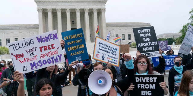 Demonstrators protest outside of the U.S. Supreme Court Tuesday, May 3, 2022 in Washington.