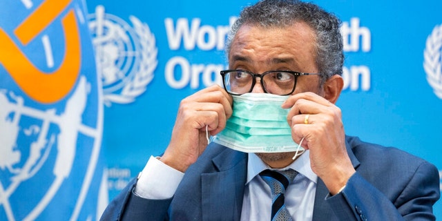 Tedros Adhanom Ghebreyesus, Director General of the World Health Organization (WHO), removes his protective face mask prior to speaking to the media at the World Health Organization (WHO) headquarters in Geneva, Switzerland.
