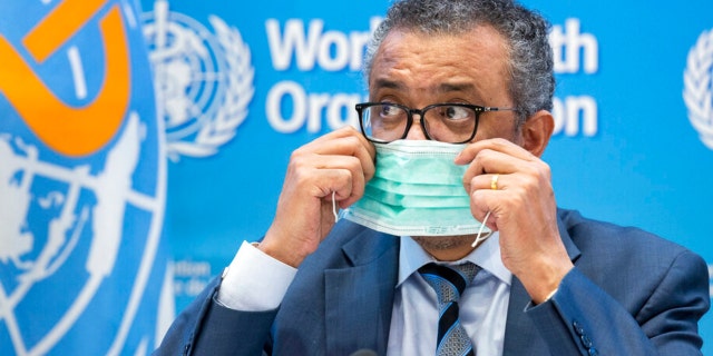 Tedros Adhanom Ghebreyesus, Director General of the World Health Organization (WHO), removes his protective face mask prior to speaking to the media at the World Health Organization (WHO) headquarters in Geneva, Switzerland.