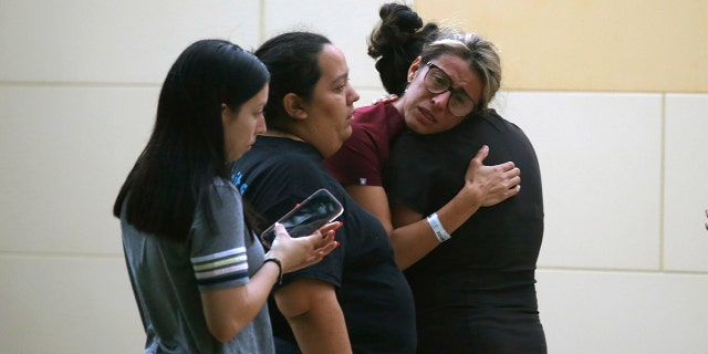 People react outside the Civic Center following the deadly school shooting at Robb Elementary School in Uvalde, Texas Tuesday, May 24, 2022.