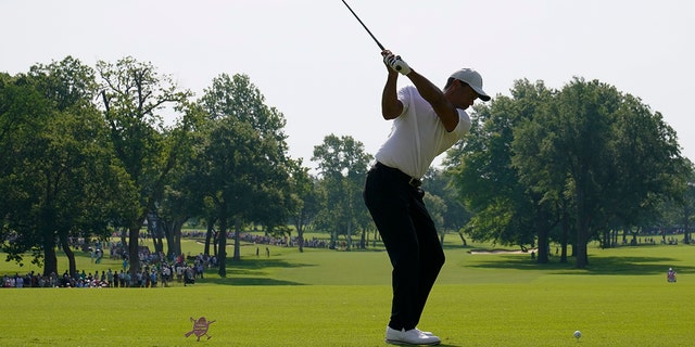 Tiger Woods hits his tee shot during a practice round for the PGA Championship, Wednesday May 18, 2022, in Tulsa, Oklahoma.