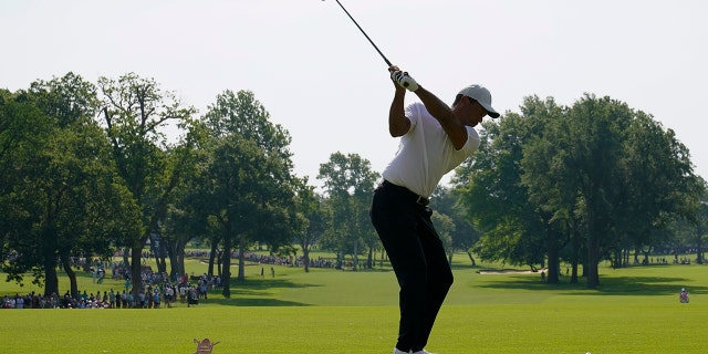 Tiger Woods hits his tee shot during a practice round for the PGA Championship, Wednesday May 18, 2022, in Tulsa, Oklahoma.