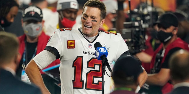 FILE - Tampa Bay Buccaneers quarterback Tom Brady (12) is interviewed on the field after the NFL Super Bowl 55 football game against the Kansas City Chiefs, in Tampa, Fla., Sunday, Feb. 2021.