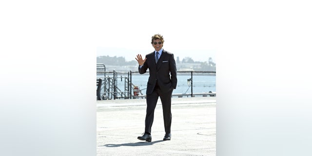 Tom Cruise waves to fans at the "Top Gun: Maverick" world premiere.