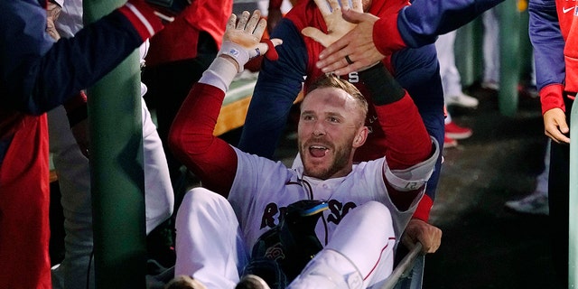 Trevor Story of the Boston Red Sox is congratulated after hitting his second two-run home run of the night during the third inning of the team's baseball game against the Seattle Mariners at Fenway Park on Thursday, May 19, 2022, in Boston.