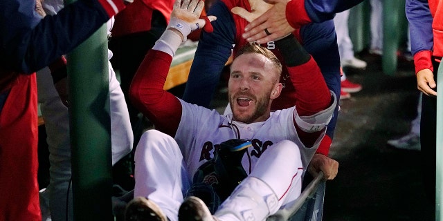 Trevor Story of the Boston Red Sox is congratulated after hitting his second two-run home run of the night during the third inning of the team's baseball game against the Seattle Mariners at Fenway Park on Thursday, May 19, 2022, in Boston.