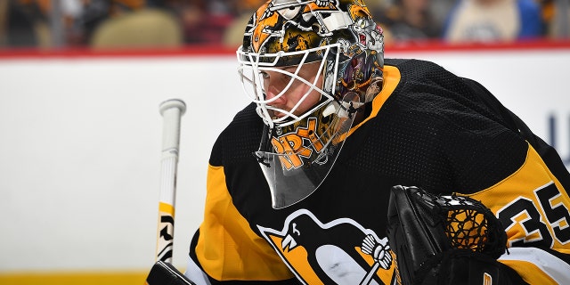 Tristan Jarry #35 of the Pittsburgh Penguins defends the net against the New York Islanders at PPG PAINTS Arena on April 14, 2022 in Pittsburgh, Pennsylvania.