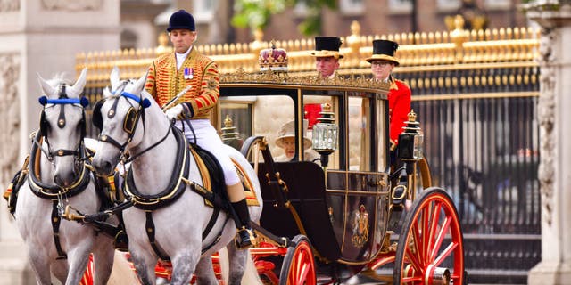 Queen Elizabeth II leaves Buckingham Palace in a carriage during Trooping the Colour.