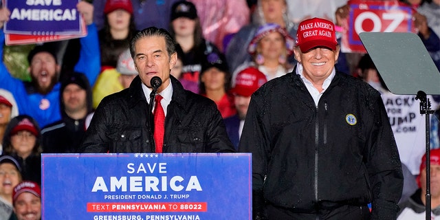 Senate candidate Mehmet Oz, accompanied by former President Donald Trump, speaks at a campaign rally in Greensburg, Pennsylvania, May 6, 2022.