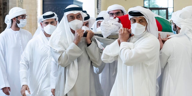 This photo, provided by the Ministry of Presidential Affairs, shows Abu Dhabi ruler Sheikh Mohammed bin Zayed Al Nahyan, front left, and Sheikh Mansour bin Zayed Al Nahyan, UAE Deputy Prime Minister and Minister for Presidential Affairs, front right, carrying the UAE. The body of President Sheikh Khalifa bin Zayed Al Nahyan, along with other members of the royal family, at the Sheikh Sultan bin Zayed I Mosque in Abu Dhabi on Friday, May 13, 2022.