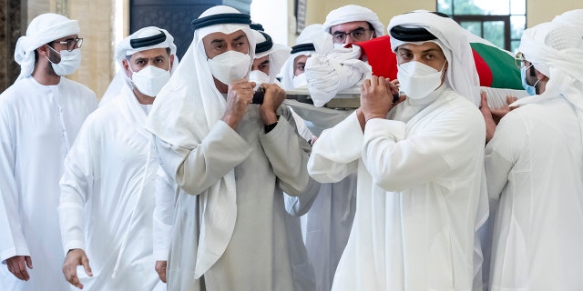 This photo made available by the Ministry of Presidential Affairs, shows Sheikh Mohamed bin Zayed Al Nahyan, ruler of Abu Dhabi, front left, and Sheikh Mansour bin Zayed Al Nahyan, UAE Deputy Prime Minister and Minister of Presidential Affairs, front right, carry the body of Sheikh Khalifa bin Zayed Al Nahyan, president of the United Arab Emirates, with other members of royal family at Sheikh Sultan bin Zayed The First mosque, in Abu Dhabi, Friday, May 13, 2022.