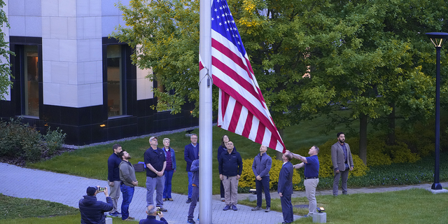 Employees of the U.S. embassy in Ukraine raise the American flag on Wednesday, May 18. (G3 Box News)