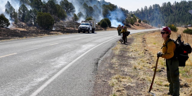 Firefighters hold the line along New Mexico's Highway 283 on Wednesday, May 4, 2022