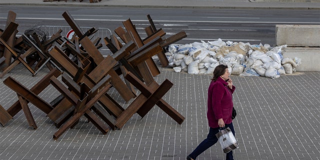 A woman walks by a metro station in downtown Kyiv, as Russia celebrates Victory Day, which marks the 77th anniversary of the victory over Nazi Germany in World War II, in Kyiv, Ukraine May 9, 2022. REUTERS/Carlos Barria