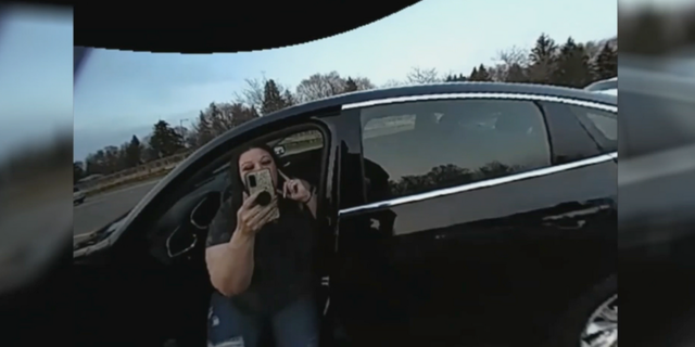 Police in Brooklyn Center, Minnesota released body camera video on Friday that shows an officer grabbing the phone of Daunte Wright's mother as she was recording officers performing a traffic stop on Wednesday.