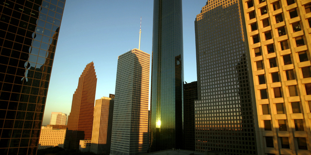 Buildings in downtown Houston reflect the light of a setting sun October 15, 2004.
