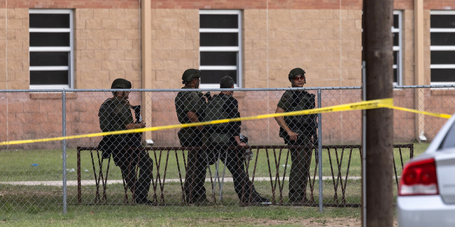 Law enforcement work the scene after a mass shooting at Robb Elementary School in Uvalde, Texas, on Tuesday, May 25.