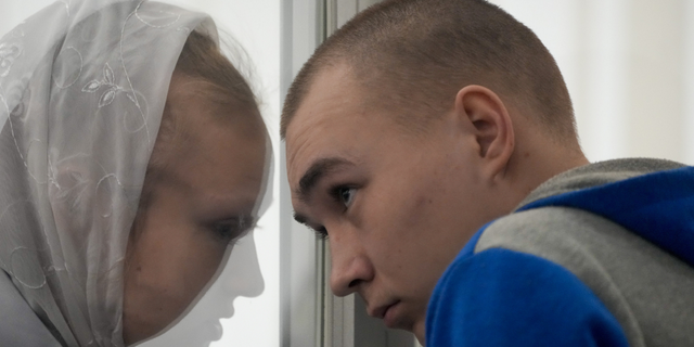 Russian Sgt. Vadim Shishimarin listens to his translator during a court hearing in Kyiv, Ukraine, on Monday, May 23.