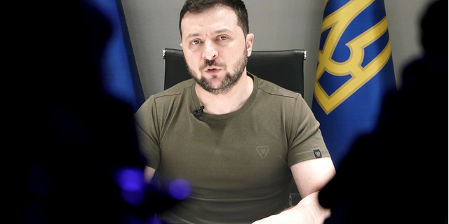 Ukrainian President Volodymyr Zelenskyy displayed on a screen as he addresses the audience from Kyiv on a screen during the World Economic Forum in Davos, Switzerland, Monday, May 23.