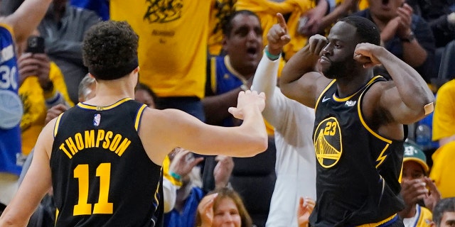 Golden State Warriors forward Draymond Green (23) celebrates next to guard Klay Thompson (11) during the first half in Game 5 of the team's NBA Conference finals matchup against the Dallas Mavericks in San Francisco Thursday, May 26, 2022.