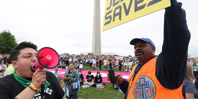 Abortion rights activist Cristela Luiz (L) confronts an anti-abortion demonstrator during a Bans Off Our Bodies rally at the base of the Washington Monument on May, 14 2022, a Washington. (Photo by Tasos Katopodis/Getty Images)