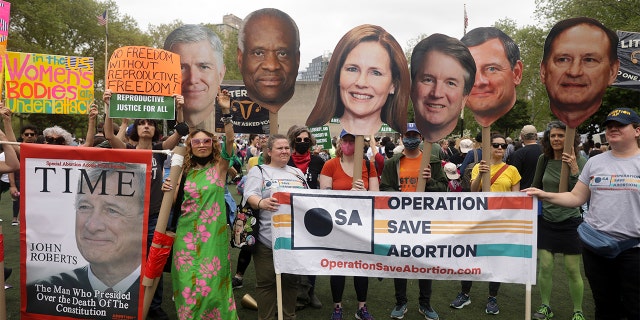 Protesters hold up signs during a pro-choice demonstration, Saturday, May 14, 2022, in New York.