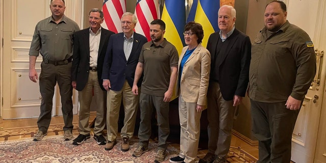 Ukrainian President Volodymy Zelenskyy takes a photo with Senate Minority Leader Mitch McConnell, Sens. John Barrasso, Susan Collins and John Cornyn, left to right, Saturday, May 14, 2022.