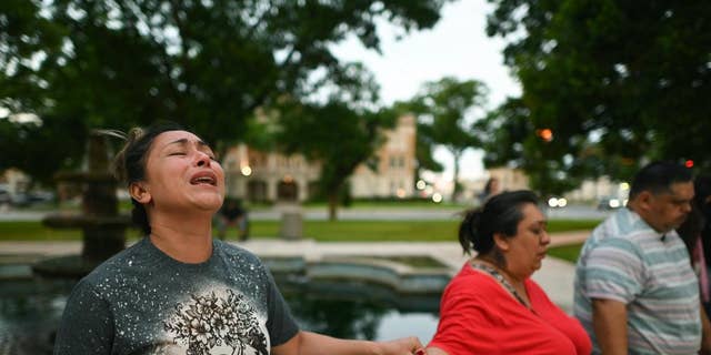 Kladys Castellón prays during a vigil for the victims of the mass shooting at Robb Elementary School in Uvalde, Texas, on Tuesday, May 24, 2022. 
