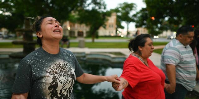 Kladys Castellón prays during a vigil for the victims of the mass shooting at Robb Elementary School in Uvalde, Texas, on Tuesday, May 24, 2022. 