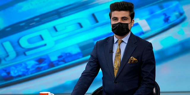TV anchor Nesar Nabil wearing a face mask to protest the Taliban's new order that female presenters cover their faces, as he read the news on TOLOnews, in Kabul, Afghanistan, May 22, 2022.
