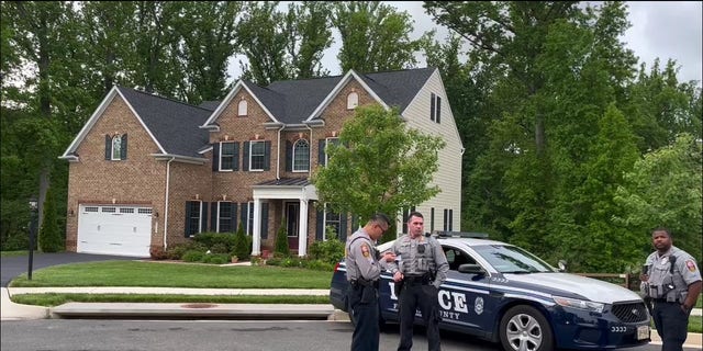 Police stationed near Supreme Court Justice Amy Coney Barrett's home in May 2022 amid protests.