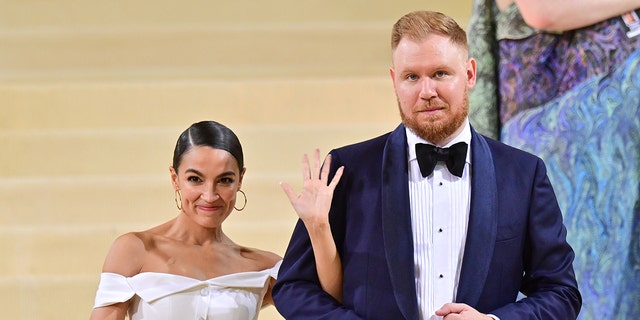 Alexandria Ocasio-Cortez and Riley Roberts leave the 2021 Met Gala Celebrating In America: A Lexicon Of Fashion at Metropolitan Museum of Art on September 13, 2021 in New York City. 