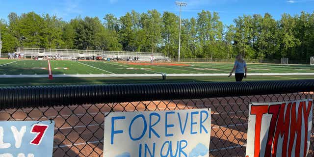 A sign reads, "Forever in our hearts" remembering Jimmy's life. 